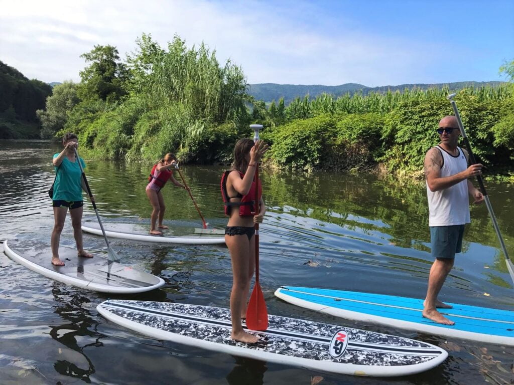 family stand up paddle boarding river